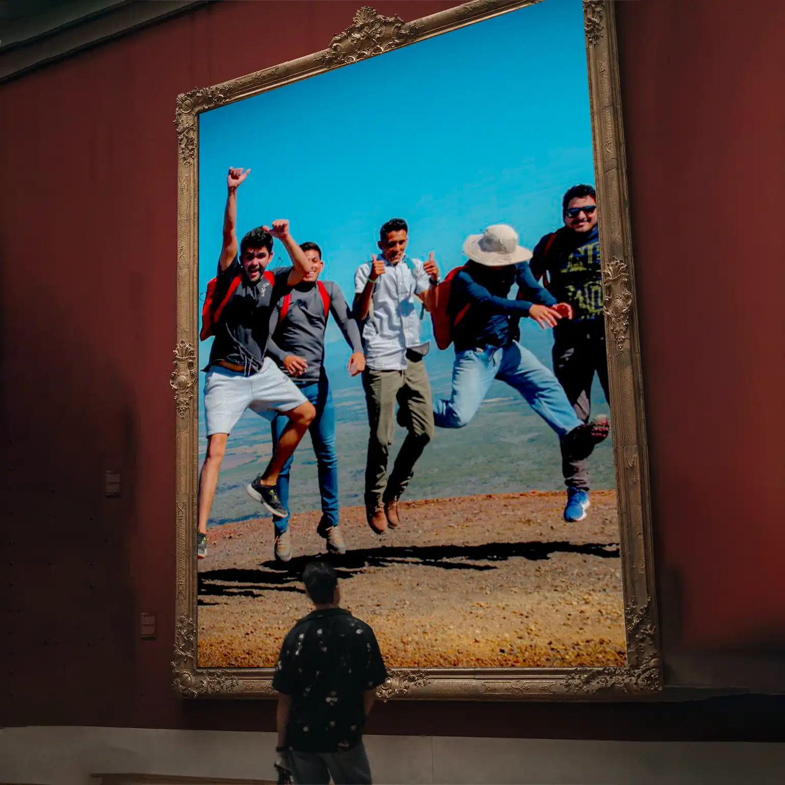 A man standing in front of a painting with people jumping